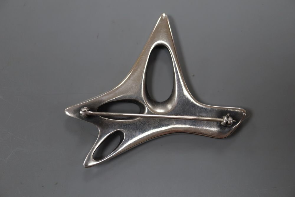 A post 1945 Henning Koppel for Georg Jensen sterling and black enamel modernist brooch, design no. 323, 58mm, gross 29 grams.